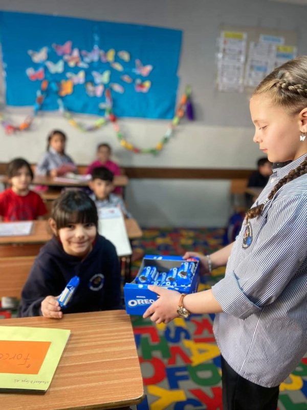 Primary students at their desks in a decorated classroom